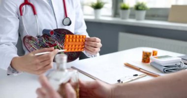 Doctor shows pills to patient for treatment of liver. Liver disease symptoms and treatment concept