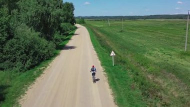 Active man on bicycle rides in nature nature. Healthy lifestyle and sports concept