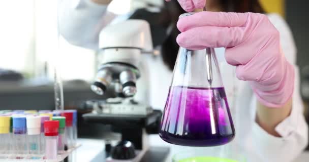 Scientist Chemist Stirring Pink Liquid Flask Laboratory Closeup Movie Slow — Stock Video