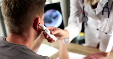 Otolaryngologist doktor klinikte hasta kulağını dijital otoskopla inceliyor. Tanı konsepti otitis medya işitme testi