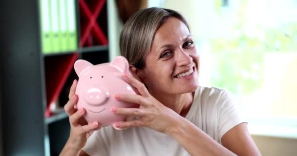 Smiling Emotionally Happy Woman Shakes Piggy Bank Financial Income Deposit — Stock Video