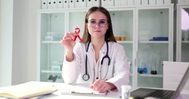 Young Doctor Holds Red Ribbon Symbol Breast Cancer Close Health — Stock Video