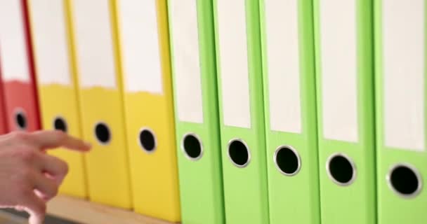 Hand Takes Out Yellow Folder Series Folders Rack Close Choosing — Stock Video