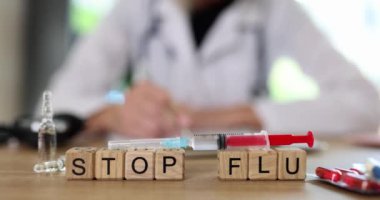 Kelimeler şırınganın yanındaki tahta bloklardan yapılan gribi durdurur. Aşıyla ve klinikte oturan doktora karşı verilen ilaçlarla. Salgın ve aşı kavramı yavaş çekim