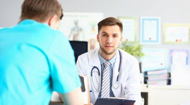 Portrait of doctor in uniform provide qualified diagnostic in clinic, specialist with stethoscope on neck wait for next patient. Medicine, hospital concept