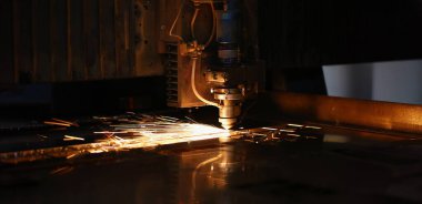 Otomatik makineden çıkan kıvılcımlar yakın plan, metalürjik arka planda metal işleme lazeri. Üretim, otomotiv üretim konsepti için parçalar