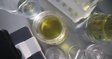 Transparent yellow oily liquid in test tube in laboratory. Development of medical marijuana oil concept
