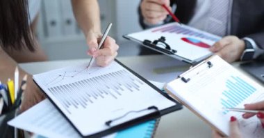 Business team studies financial indicators in charts. Analytics and statistics in marketing concept