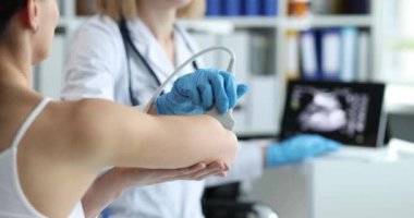 Doctor conducts diagnostics of ultrasound of bones of hands of clinic. Pain in joints of hands concept