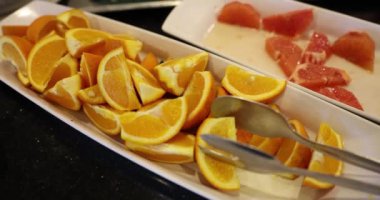 Summer fruit plate with slices of juicy fresh oranges on plate. Delicious and healthy food for vegetarians.