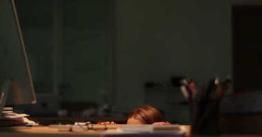 Panik atak geçiren bir kadın fırtına sırasında masasının arkasına saklanır. Şirket işyerindeki aşırı yüklenen işlerden korkan kadın katip.