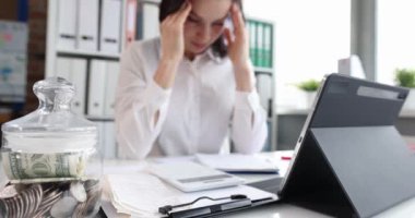 Upset businesswoman with headache at workplace. Overtime and business error reporting concept