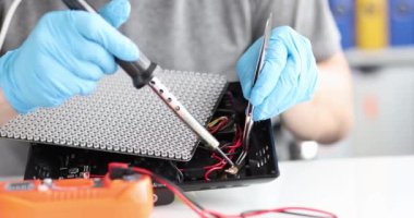 Soldering repair of electronic devices and printed circuit boards. Computer board and lighting equipment repair service concept