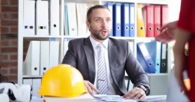 Builder and contractor shaking hands while meeting house renovation project and investment financing. Commercial partnership negotiations and residential building renovation engineer and customer