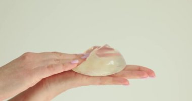 Plastik cerrahın ellerinde silikon implantlar. Göğüs büyütme ve kaldırma