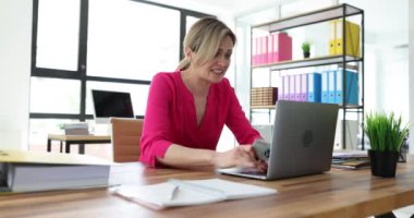 Genç bir kadın dizüstü bilgisayarına karşı banka kartını elinde tutmaya mahkum. Ofisteki bayan internette aldatıldığının farkında. İnternet dolandırıcılığı kavramı