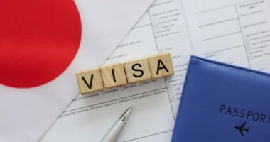 Kelime vizesi Japon bayrağı ve başvuru kağıtlarındaki tahta küplerden yapılmış. Güvenli seyahat deneyimi için gerekli belgelerin hazırlanması kavramı
