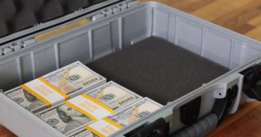 Doldurulmuş banknotlar plastik evrak çantasını dolduruyor. Zenginlik ve finansal anlaşmaları temsil eden konteynıra sıkıca doldurulmuş para paketleri