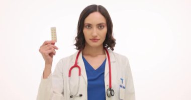 Kadın doktor beyaz arka planda hap ve prezervatif tavsiye ediyor. Kadın jinekolog hastaları doğum kontrol seçenekleri konusunda uyardı