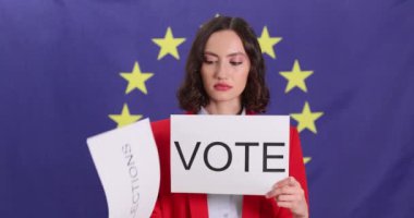 Ciddi bir kadın Avrupa Birliği bayrağına karşı seçiminizin önemli olduğuna dair işaretler gösteriyor. Kadın, demokratik süreçleri ağır çekimde destekliyor