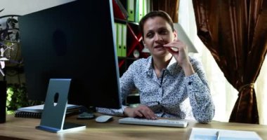 Profesyonel bir kadın, modern bir ofis masasında bilgisayar aygıtı ile yaratıcılığını tamamen ortaya koyuyor.