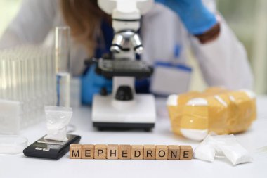 A detailed closeup shot of a laboratory setting where scientists are analyzing mephedrone using a microscope clipart