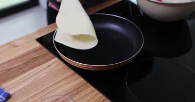 Profesyonel aşçı indüksiyon sobasında ince krep çevirir. Tecrübeli şef, mükemmel kahverengi renkte krep pişirir. Yavaş çekim