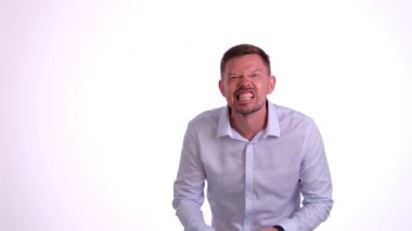 Gömlek giyen bir adam abartılı bir yüz ifadesiyle derin hayal kırıklığını açıkça ifade ediyor.