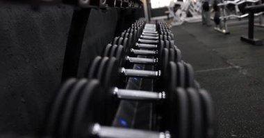 Modern bir spor salonu ortamında şık bir halterin iyi odaklanmış görüntüsü, fitnesle ilgili medya içeriği için ideal
