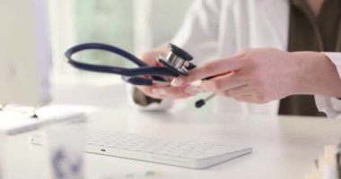 Doktor hastayı muayene etmeyi bitirir ve stetoskobu masaya yerleştirir. Doktor aletleri kulaklarından çıkarır ve randevu üzerine masaya yatırır. Yavaş çekim