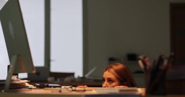 Gök gürültülü şimşeklerden korkan bir kadın elleriyle yüzünü kapatıyor ve masanın altında oturuyor. Loş ışıklandırma çalışma alanı gergin atmosfere katkıda bulunuyor