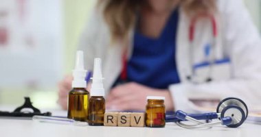 Tahta bloklardaki kısaltma RSV burun spreyleri ve doktor aleyhinde haplar. Kadın hekim ortak solunum hastalığının tedavisini seçti