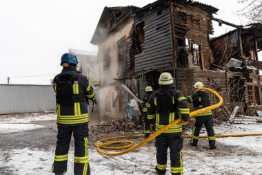 Vovchansk, Kharkiv Oblast  Ukraine - February 01 2023: Firefighters extinguish fire blown up by a mine during Russian shelling of a peaceful town in Ukraine