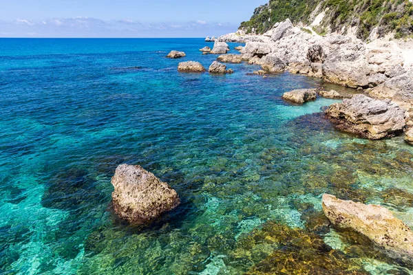 stock image  A beautiful landscape of the coast of the island of Corfu in the Ionian Sea of the Mediterranean in Greece. Pure blue clear water washes over the shores of the Greek island.