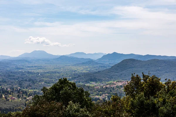 stock image A beautiful landscape of the island of Corfu in the Ionian Sea in Greece. Mountains with plenty of green vegetation. Thick clouds over the island.