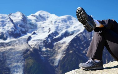 Hiker resting in the Graian Alps. Mont Blanc mountain range, Nature Reserve Aiguilles Rouges, France.