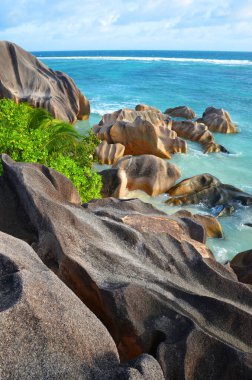 Anse Source d'Argent beach with big granite rocks in sunny day. La Digue Island, Indian Ocean, Seychelles. Tropical destination.