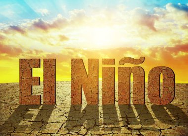 Landscape with dry cracked soil and El Nino text at sunset. Concept of change climate.
