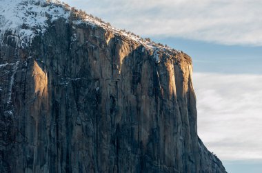 close-up of el capitan, catching the first rays of the rising sun on an early morning winter afternoon.
