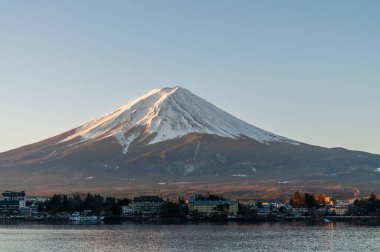 Mount Fuji on a bright winter morning, as seen from across lake Kawaguchi, and the nearby town of Kawaguchiko.