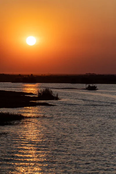stock image Telephoto shot of the setting sun over the chobe river on a bright winter afternoon in Botswana.