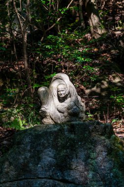 Hiroshima, Japan - January 2, 2020. Close-up of a statue at the famour Mitaki Dera Temple in Hiroshima Japan.