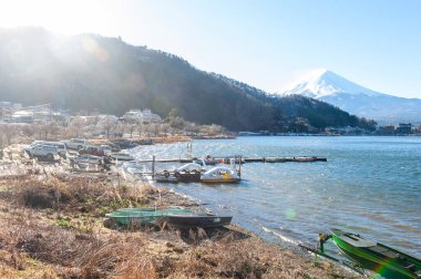 Mount Fuji on a bright winter morning, as seen from across lake Kawaguchi, and the nearby town of Kawaguchiko.