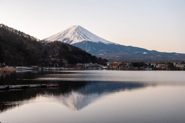 Mount Fuji on a bright winter morning, as seen from across lake Kawaguchi, and the nearby town of Kawaguchiko.