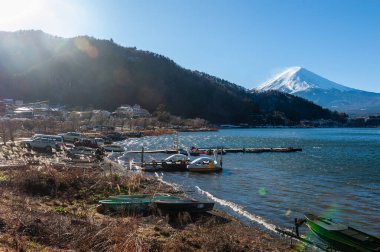 Mount Fuji on a bright winter morning, as seen from across lake Kawaguchi, and the nearby town of Kawaguchiko.