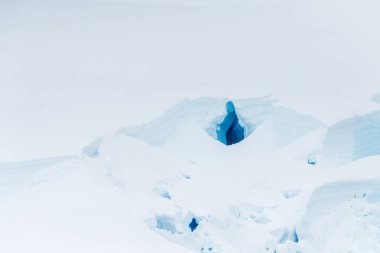 Graham yakınlarındaki sakin bir Antarktika manzarası, Charlotte Körfezi boyunca uzanır, sert yansımaları, engebeli dağları ve etkileyici buzdağlarını vurgular..