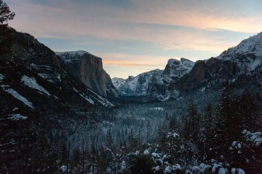 Panoramic view over Yosemite valley, from Tunnel view, showing a snow-covered valley at Dawn