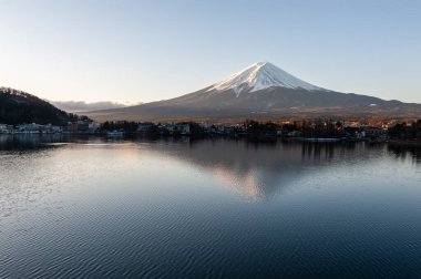 Mount Fuji on a bright winter morning, as seen from across lake Kawaguchi, and the nearby town of Kawaguchiko.