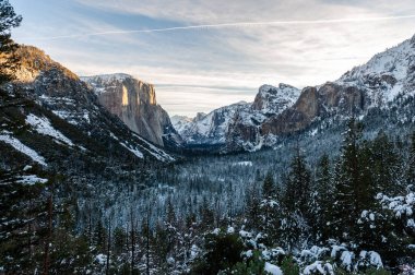 Wide-angle shot of Yosemite valley from tunnel view on an early winter morning. El capitan catches the first rays of sunlight of the new year.