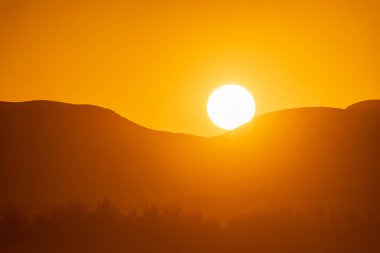 Namibya ve Güney Afrika sınırında, Orange Nehri üzerinde gün batımı.